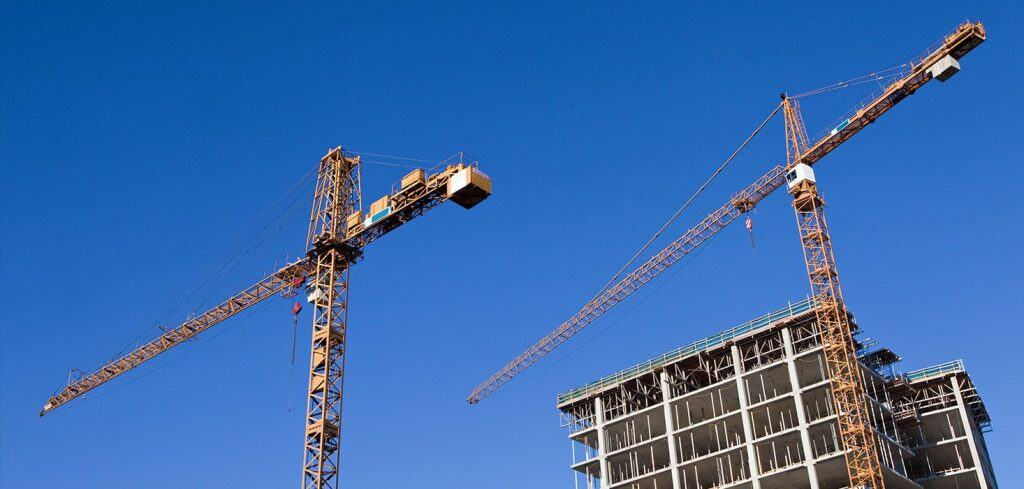 Two construction cranes