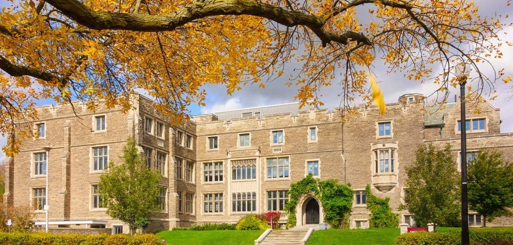 An old university with trees and autumn leaves