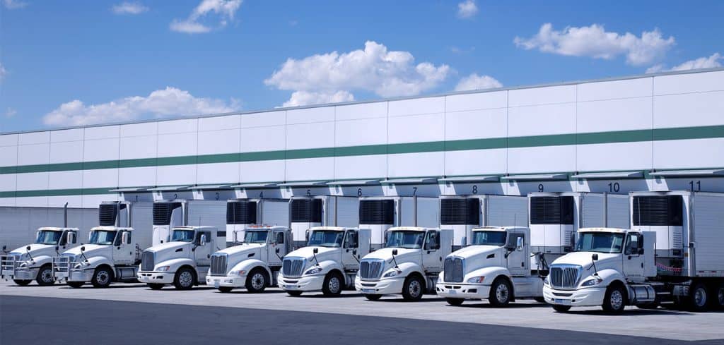 Large warehouse with trucks waiting to be loaded