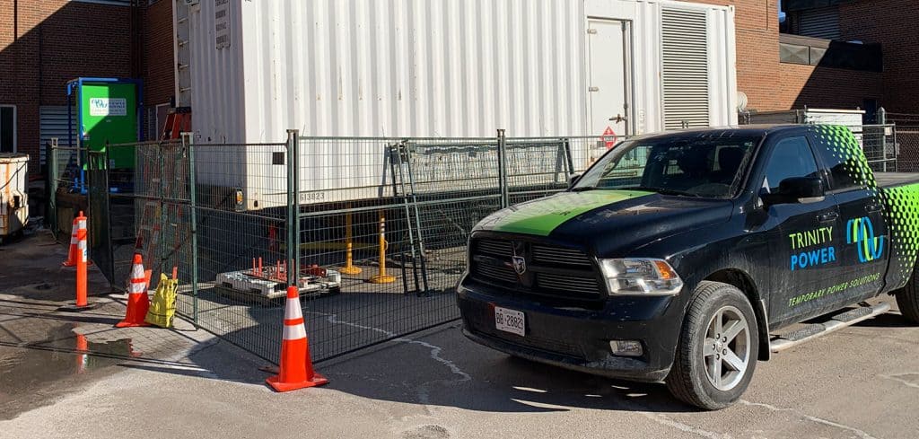 Trinity truck in front of a generator.