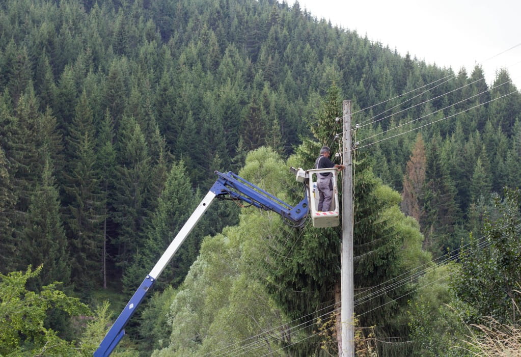 Engineer working on pole powerlines